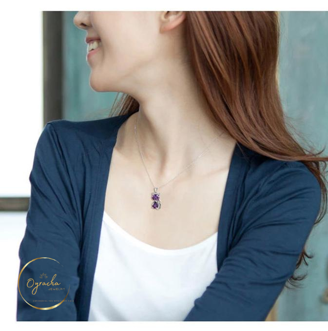 "Model wearing an elegant amethyst cat pendant necklace, captured from a side angle view, by Oyracha Jewelry. The necklace features sparkling purple gemstones, symbolizing protection and intuition, perfect for zodiac-inspired jewelry lovers. Discover Oyracha's gemstone and zodiac collection."