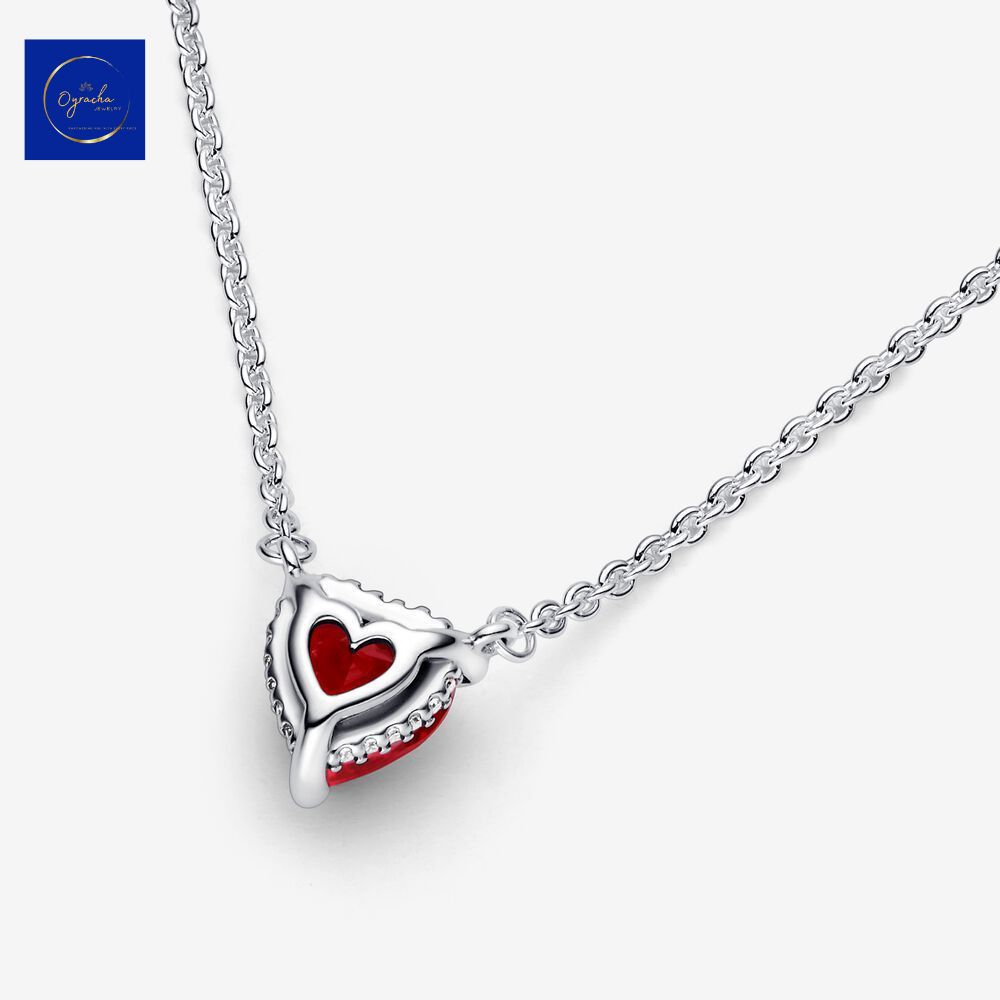 "Back angled view of a ruby heart necklace with intricate silver detailing by Oyracha Jewelry. Showcasing the reverse design of the heart-shaped ruby pendant, this unique perspective highlights the craftsmanship and elegance of the piece. Discover more at Oyracha's jewelry collection."