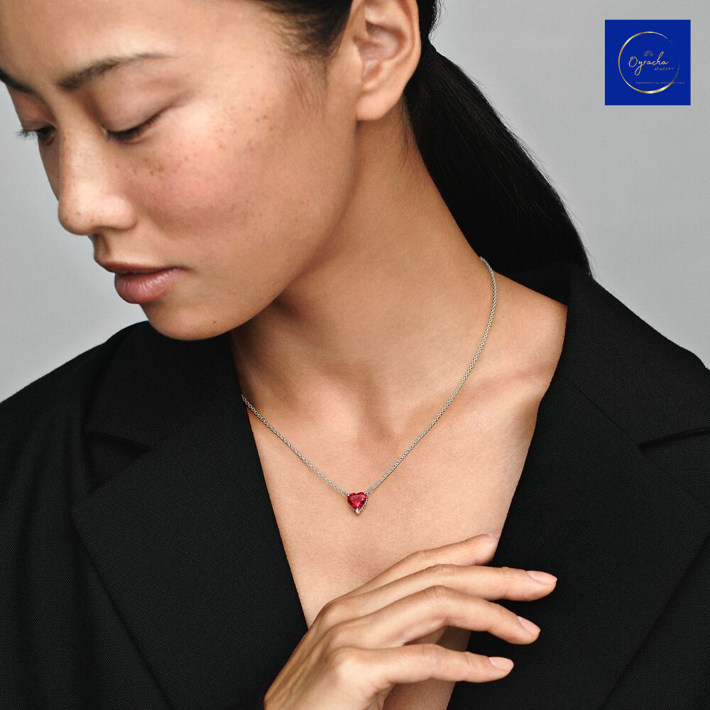 "Ruby heart necklace worn by a model, captured from a front view, by Oyracha Jewelry. The striking red gemstone adds a touch of elegance and passion, making it a timeless accessory. Discover more at Oyracha's gemstone jewelry collection."