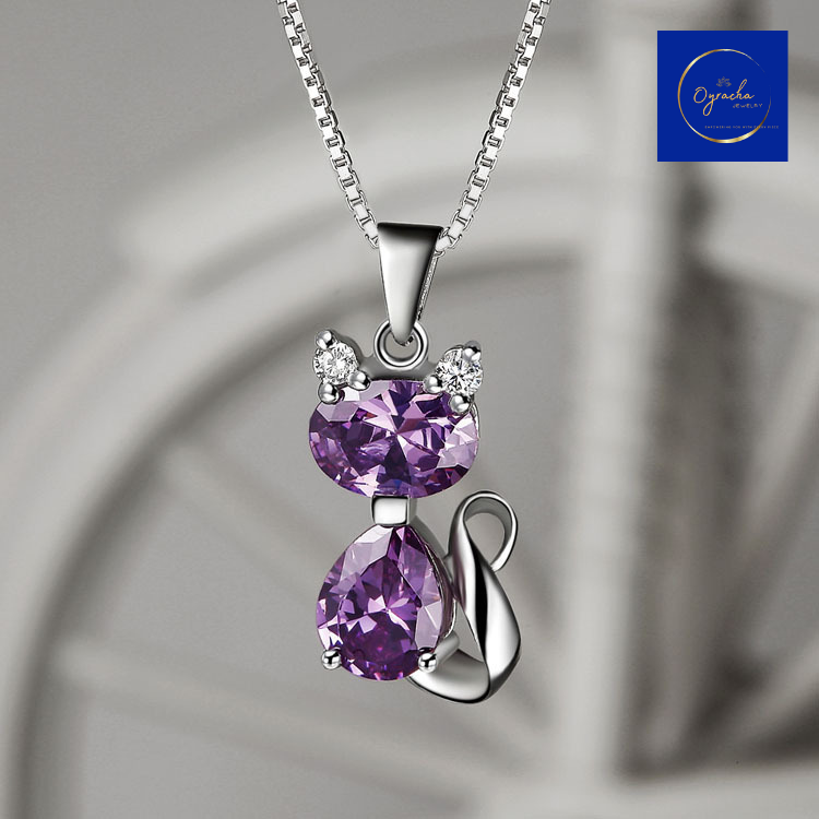 "Elegant amethyst cat pendant necklace featuring two sparkling purple gemstones, captured from a front angle view, by Oyracha Jewelry. This playful yet sophisticated piece symbolizes intuition and protection, making it perfect for individuals born under the Chinese zodiac sign Dragon. Explore Oyracha's zodiac and gemstone jewelry collection."