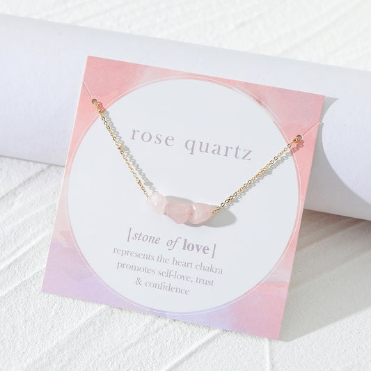 
Here’s the SEO-optimized ALT text for this product picture:

"Angled view of a rose quartz necklace displayed on a branded card by Oyracha Jewelry. The necklace features raw rose quartz gemstones on a delicate gold chain, with the card highlighting rose quartz as the stone of love, associated with the heart chakra, promoting self-love, trust, and confidence. Perfect for a meaningful gift."