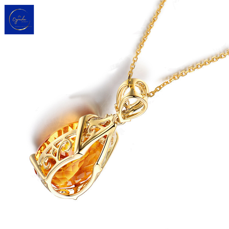 Back angle view of an exquisite citrine pendant necklace from Oyracha Jewelry. This image showcases the intricate gold filigree design on the back of the pendant, beautifully highlighting the craftsmanship and attention to detail in this elegant piece, featuring a radiant citrine gemstone.