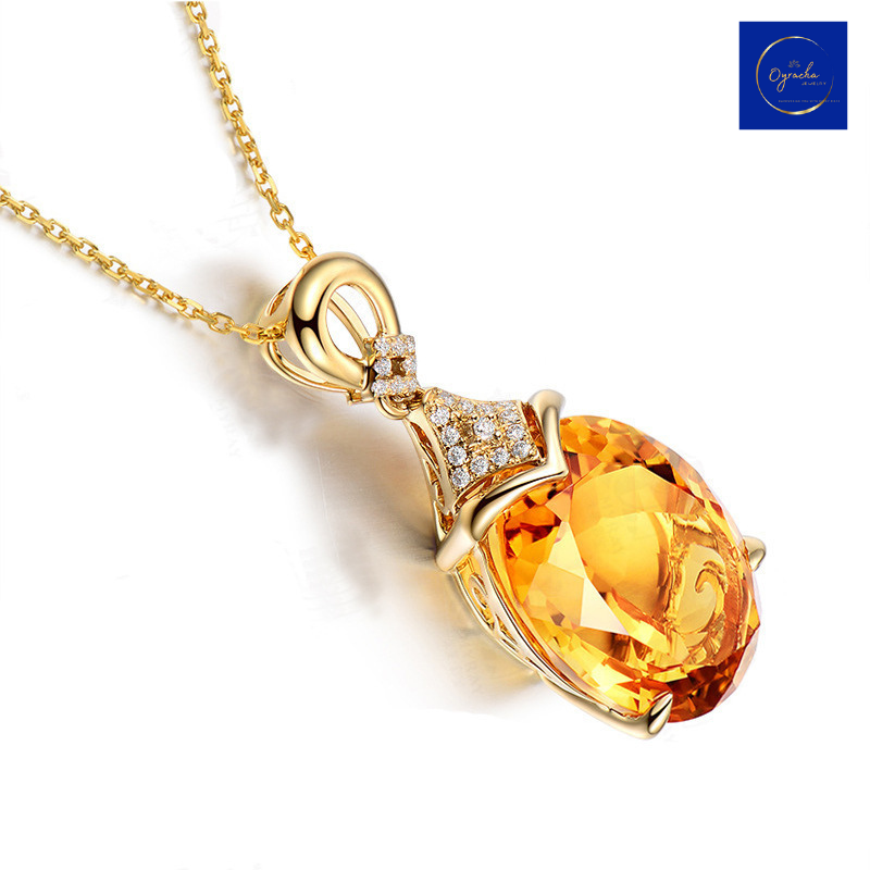 Side angle view of a dazzling citrine pendant necklace from Oyracha Jewelry. This close-up highlights the intricate details of the gold setting, sparkling diamonds on the bail, and the brilliance of the oval-cut citrine gemstone, perfect for elegant and timeless style