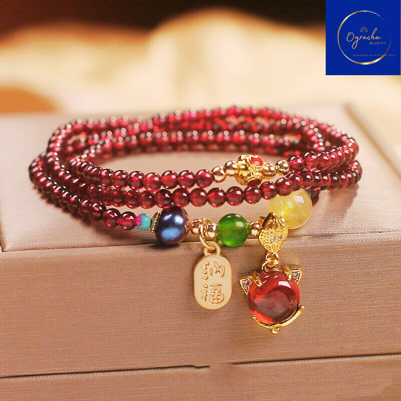 "Beautiful multi-strand garnet bracelet with colorful gemstone accents and gold charms, captured from a front angle view, by Oyracha Jewelry. This handcrafted piece symbolizes prosperity and protection, ideal for those seeking zodiac-inspired gemstone accessories. Explore Oyracha's gemstone and zodiac jewelry collection."