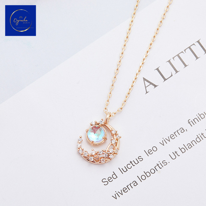 "Delicate rose gold moonstone necklace featuring a crescent and floral design, captured from a top-down angle view, by Oyracha Jewelry. The shimmering moonstone symbolizes intuition and inner calm, perfect for those seeking elegance and meaning. Explore Oyracha's zodiac and gemstone jewelry collection."