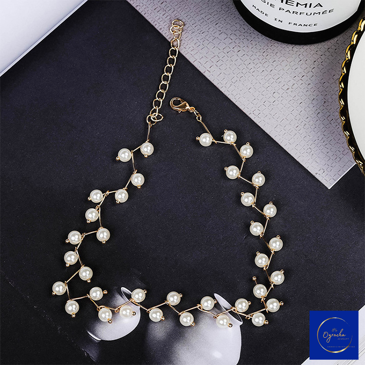 Top view of a gold pearl choker necklace from Oyracha Jewelry, featuring a branch-inspired design with elegant pearls. The adjustable clasp is visible, ensuring a customizable fit. This necklace is perfect for adding a touch of sophistication to both formal and casual outfits.