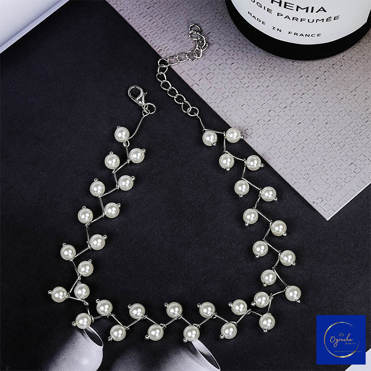 Top view of an elegant silver pearl choker necklace from Oyracha Jewelry, showcasing a delicate branch-like design with lustrous pearls. The adjustable chain clasp is featured for a secure and comfortable fit, making this necklace a refined accessory for both special occasions and everyday elegance