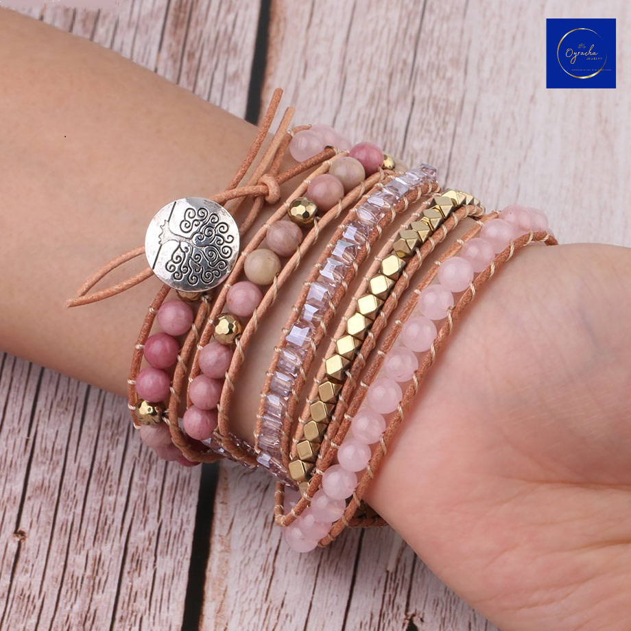 "Stylish rose quartz wrap bracelet with natural stone beads and gold accents, displayed on a wrist from a front angle view, by Oyracha Jewelry. This elegant piece symbolizes love and healing, making it a perfect addition to any zodiac and gemstone-inspired collection. Explore Oyracha's handcrafted jewelry."