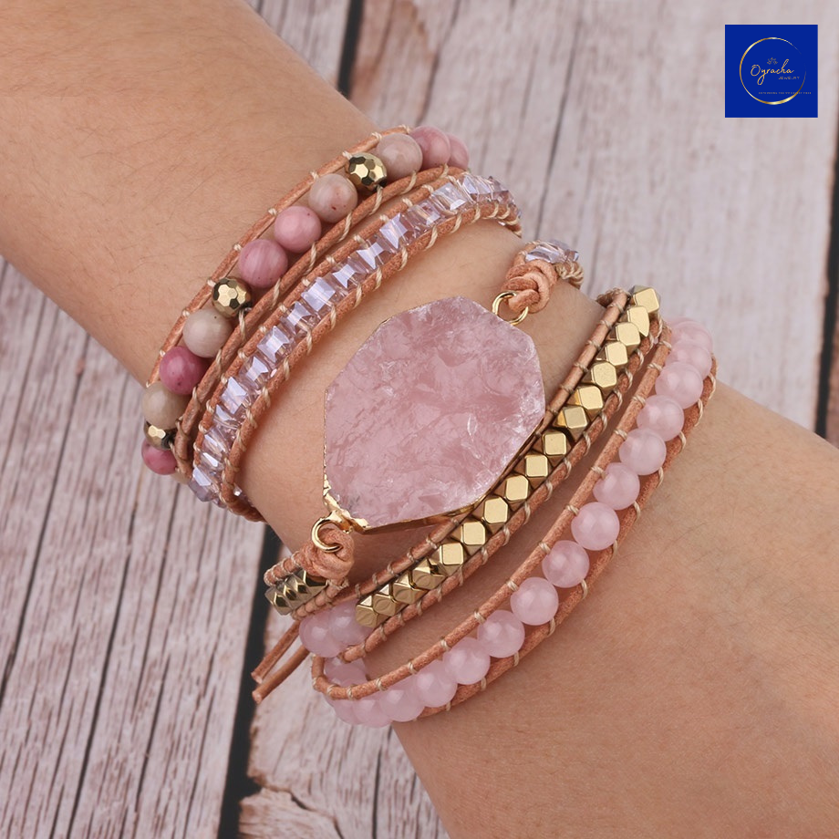 "Stylish rose quartz wrap bracelet with natural stone beads and gold accents, displayed on a wrist from a front angle view, by Oyracha Jewelry. This elegant piece symbolizes love and healing, making it a perfect addition to any zodiac and gemstone-inspired collection. Explore Oyracha's handcrafted jewelry."