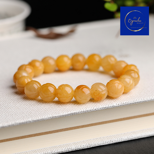 "Golden topaz gemstone bracelet, captured from a side angle view, by Oyracha Jewelry. The round, polished topaz beads symbolize prosperity and positive energy, making this bracelet ideal for individuals born under the Chinese zodiac sign Horse. Explore Oyracha's zodiac and gemstone jewelry collection."